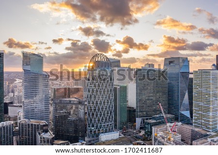 Aerial drone shot of La Defense business district skyscrapers during sunset