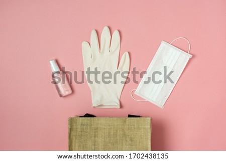 Table top view aerial image of accessories office desk for work from home background concept.Flat lay of Essential equipment tools face mask with red heart and hand sanitizer or alcohol gel.copy space