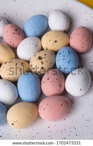 Easter eggs lie on a yellow background