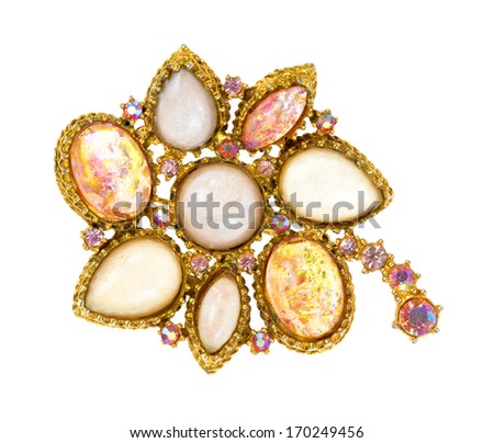 A very old brooch showing details on a white background.