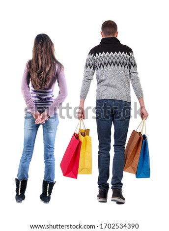 back view of couple with shopping bags. backside view of person. Rear view people collection. Isolated over white background.