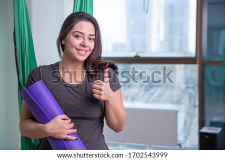 Portrait of young yoga woman yoga trainer indoor. Beautiful girl practice yoga in class. Yoga studio instructor. Blurred background