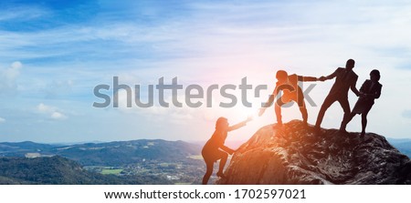Success of business concept. Partnership of business. Group of businessperson on the mountaintop. Royalty-Free Stock Photo #1702597021