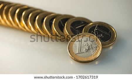 One euro coin on the background of a lying stack of euros. Business concept. Web banner.
