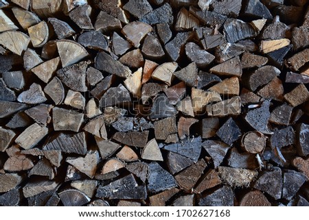 Firewood in a woodpile, vintage texture. Chipped firewood as a background
