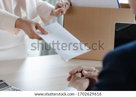 Office worker sending resignation letter to manager. Royalty-Free Stock Photo #1702629616