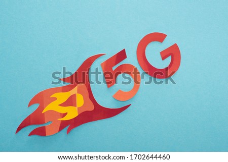 top view of red 5g with flame lettering on blue background