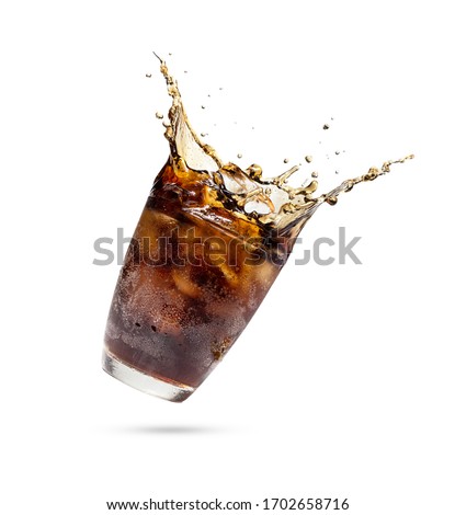 Studio shooting Cola splashing out of a glass.Cola in glass with splash of ice isolated on white background with clipping path