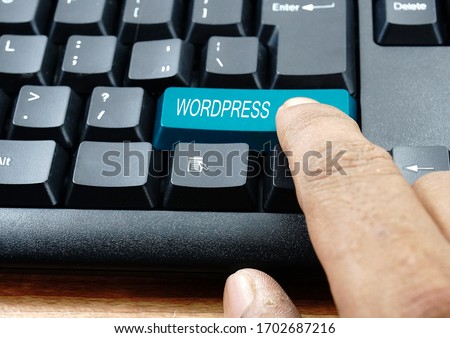 Finger press blue Wordpress keyboard button
