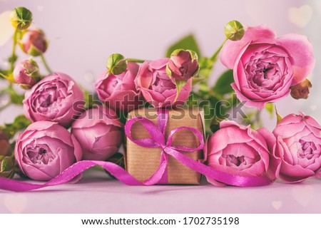 Gift present box with beautiful pink flowers roses bouquet. Greeting card for Mother's Day, Happy Birthday or Woman and Valentine's Day. Toned image.