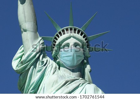 Statue of liberty wearing a surgical mask. Concept of Coronavirus, COVID-19, isolation, protection and quarantine