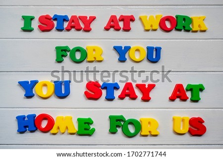 I Stay at work for you you stry at home for us Sign & Symbol, plastic letter on white wood background