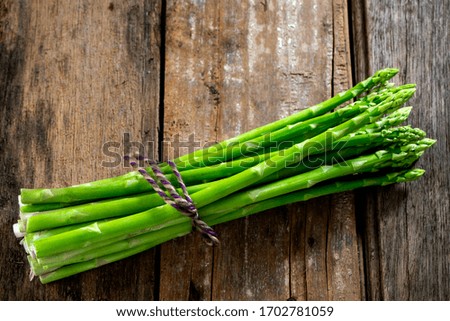 Group of Fresh asparagus on the wood background, raw vegetable food for health cook more copy space.