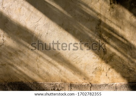 The sun is casting over the old concrete wall, sunshade shadow, background, texture