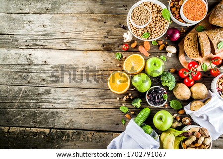 Healthy food. Selection of good carbohydrate sources, high fiber rich food. Low glycemic index diet. Fresh vegetables, fruits, cereals, legumes, nuts, greens. Wooden background copy space Royalty-Free Stock Photo #1702791067