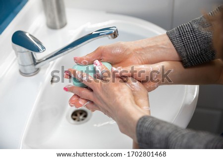 Mother washing hands her son carefully with soap and sanitizer, close up. Prevention of pneumonia virus spreading, protection against coronavirus pandemia. Hygiene, sanitary, cleanliness, disinfection