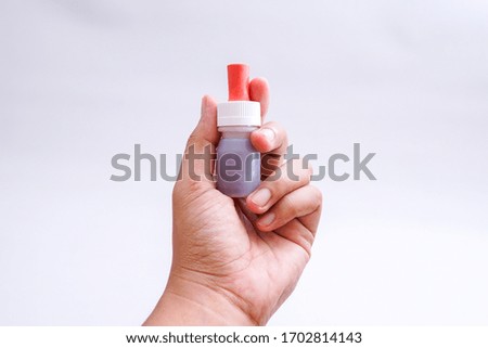 the bottle containing the vaccine in the hand