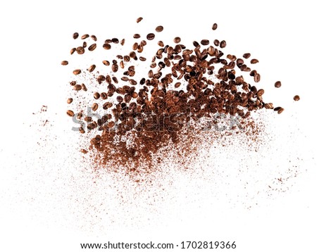 Explosion of coffee beans and ground coffee, close up