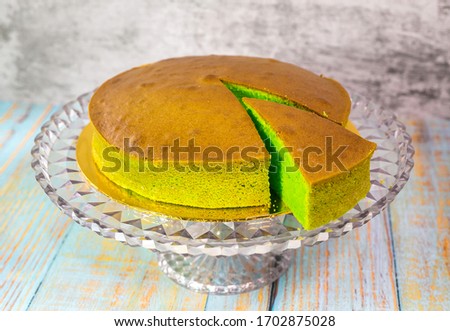Green pandan cake with icing sugar on top large picture hd background