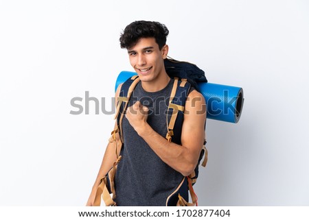 Young Argentinian hiker man over isolated white background celebrating a victory