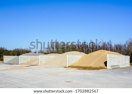 Aggregate for concrete production at stockpile of concrete mixing plant Royalty-Free Stock Photo #1702882567