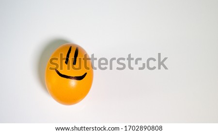 Funny chicken egg with a smile,funny. Close-up.On a white background.