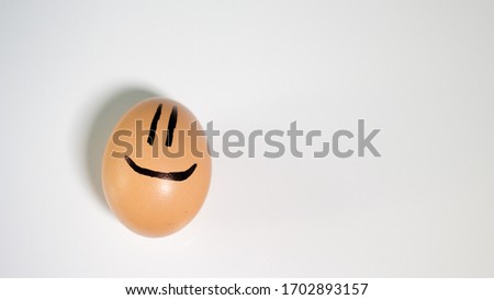 A chicken egg, with a smile,with a smile,for a postcard,funny.