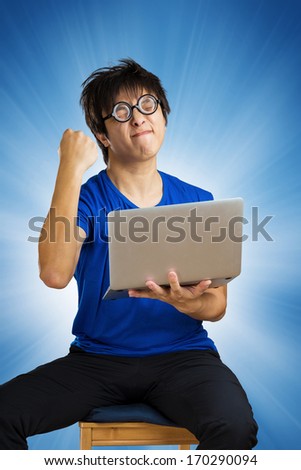 Crazy happy guy with computer laptop on blue background