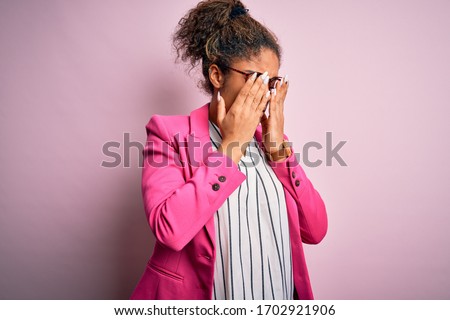 Beautiful african american businesswoman wearing jacket and glasses over pink background rubbing eyes for fatigue and headache, sleepy and tired expression. Vision problem