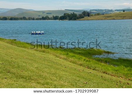 Floating jetty moored in blue water of midmar dam