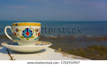 Hot Turkish coffee on the beach wooden table. Relaxation mood, resting vacation. Leisure in sunny summer day. Beautiful low view of life with pleasure. 