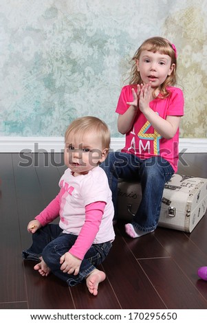 Sisters - Two little girls together in studio