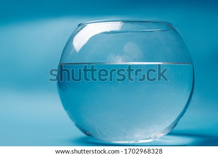 
Transparent aquarium with water on a blue background