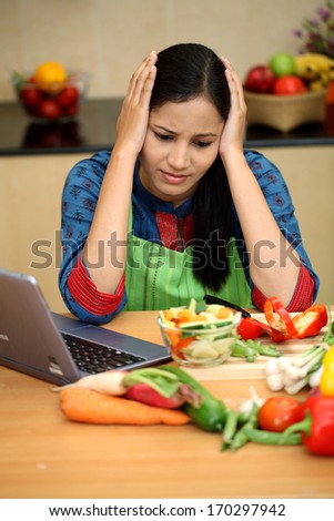 Stressed young woman in kitchen 