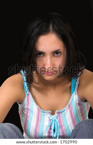 serious teenager over a black background