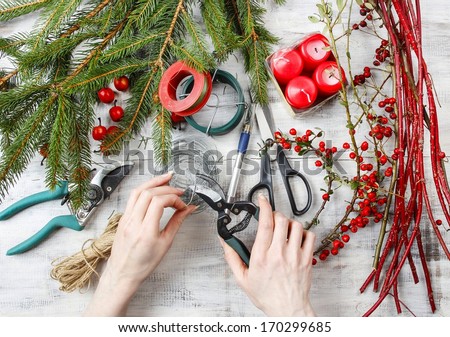 Florist workspace: woman making floral decorations for christmas