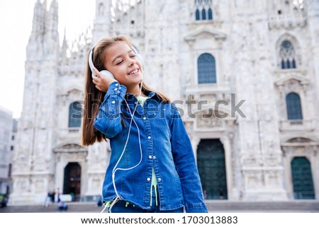 Beautiful child enjoy her holiday in front of Duomo Milan