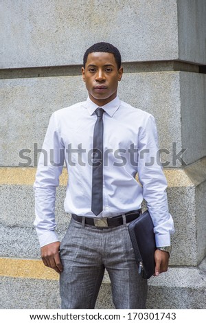 white shirt, a black tie, gray pants 