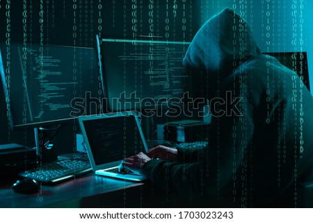 Cyber criminal hacking system at table, digital binary code on foreground Royalty-Free Stock Photo #1703023243