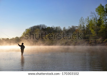 Fly fisherman fishing for Striped Bass in Nova Scotia. Royalty-Free Stock Photo #170303102