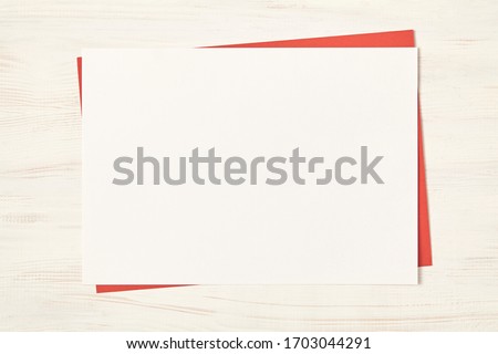 White empty blank paper on wood background. Top view.