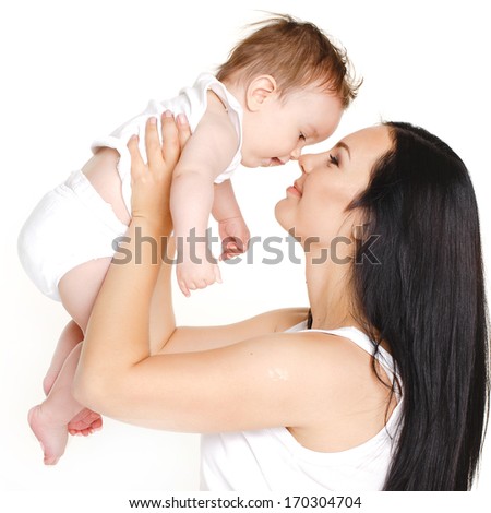 portrait of Happy cheerful family. Mother and baby kissing, laughing and hugging. Playful mood