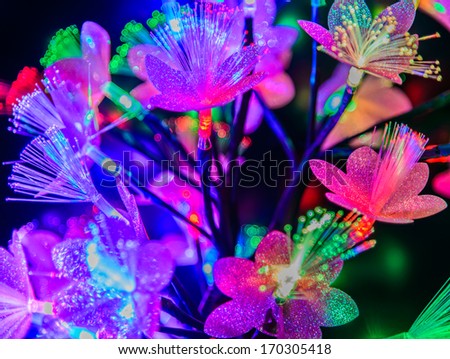 Glowing abstract multicolored flowers on a dark background