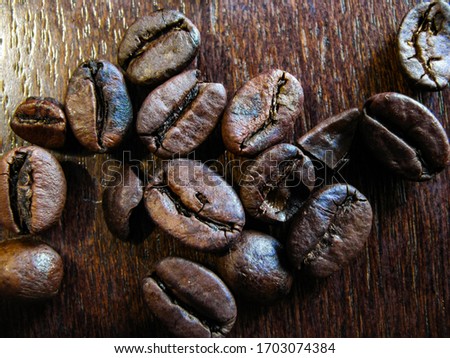 some coffee beans on a wooden table