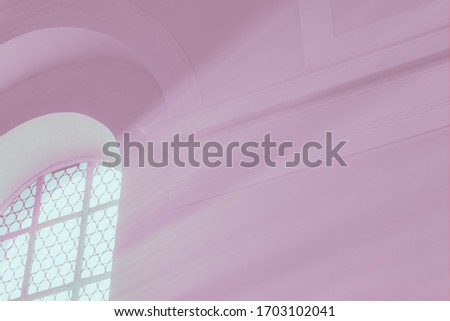 Light rays through the arch window. Pink plum colors, toned photo