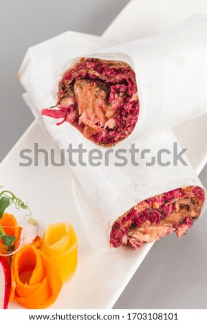 Delicious salmon and beetroot shawarma for healthy living. Food photography perfect for delivery and takeaway concept focus view.