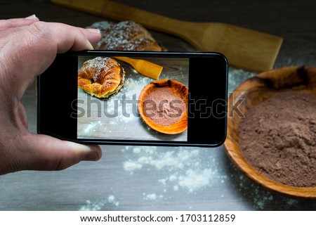 Taking a picture with a mobile phone of a cake