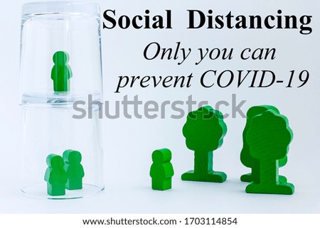 Toy wooden people under a glass on light background with text. Concept of staying physically apart, at home, social distancing, quarantine during pandemic of coronavirus COVID-19.