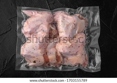 Prepack chicken marinated in sauce and spices package blowing (bagginess) in vacuum packaged ready to eat. Royalty-Free Stock Photo #1703155789