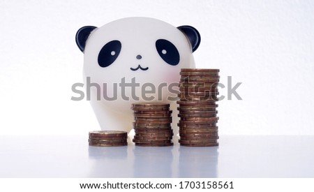 Stack coins with panda bank. Savings Concept. 